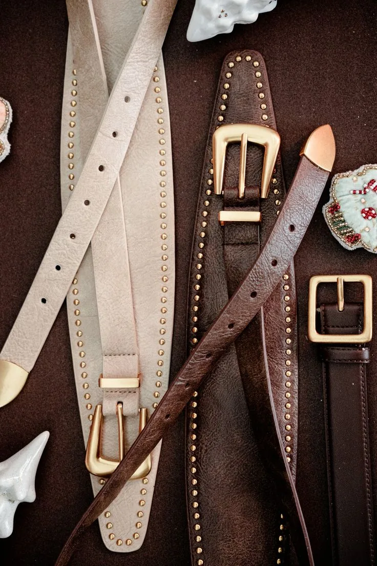Leather Belts and Buckles | ZESTLET Accessories Brown and cream leather belts with gold-tone buckles and decorative studs.